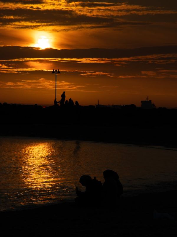 Person meditating peacefully in a calm, dark environment with a soft ruby glow.